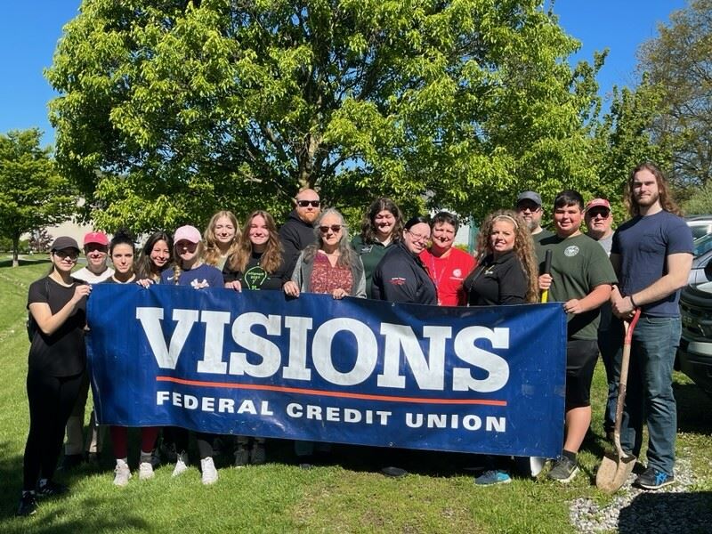 Arbor day 2023 shade tree commission and volunteers holding a banner from Visions Federal Credit Uni