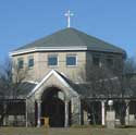 Saint Joseph's Catholic Church, an octagonal building in pale brick with a cross on the roof